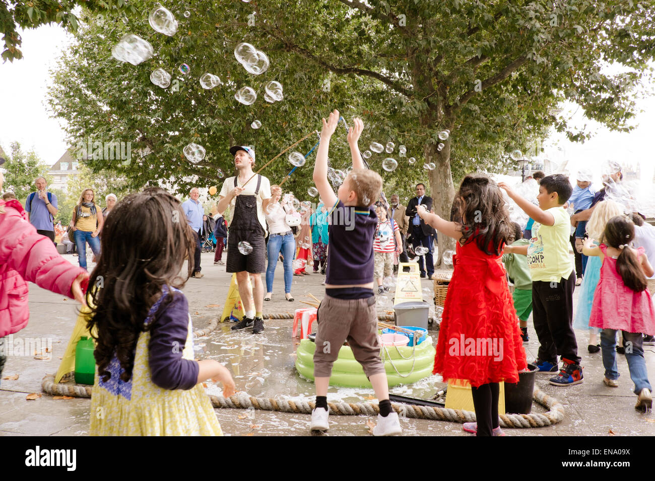Street entertainer making bubbles on the Thames embankment London UK Stock Photo