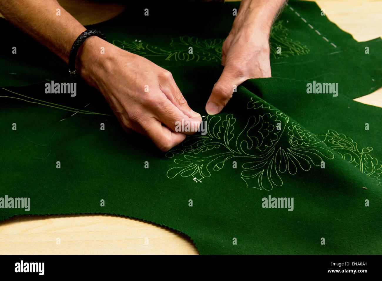 embroidering the green Loden vest of a traditional costume in Ausseerland, Bad Aussee, Austria Stock Photo