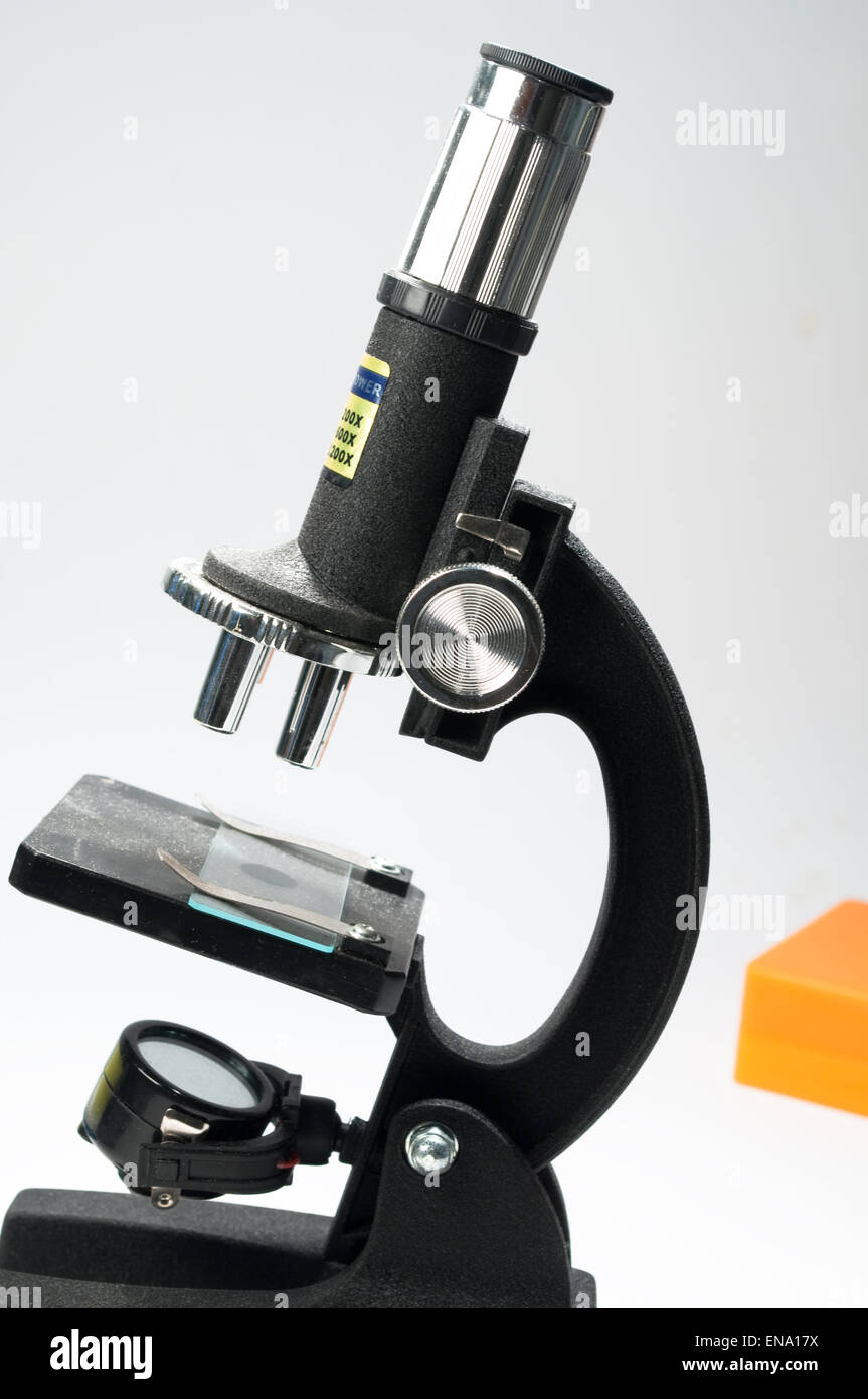 Black microscope, on a white background. Scientific equipment - optical device in a biological laboratory. Stock Photo