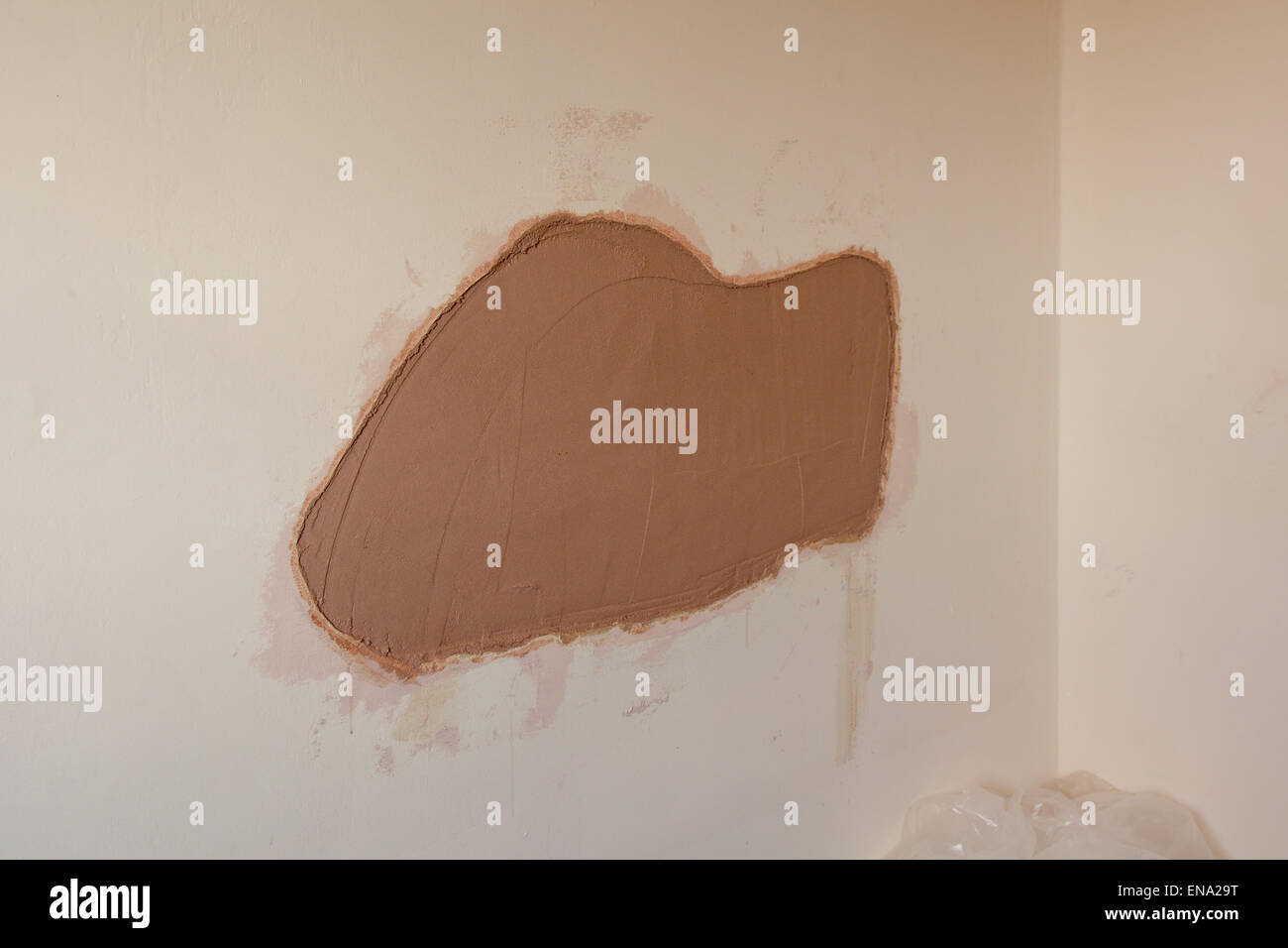Plastering work to repair hole in wall Stock Photo Alamy