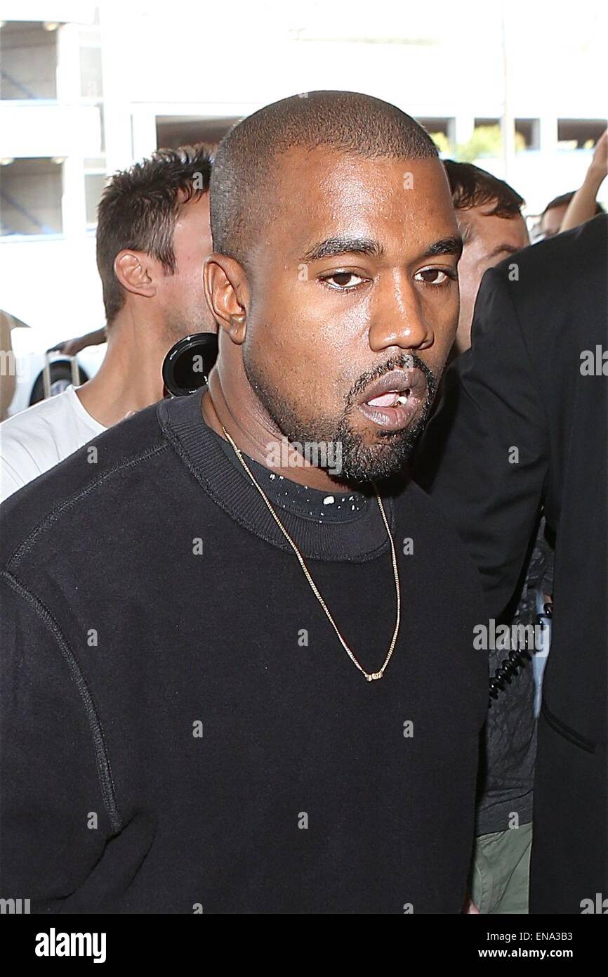 Kim Kardashian and Kanye West leave from Los Angeles International Airport (LAX)  Featuring: Kanye West Where: Los Angeles, California, United States When: 26 Oct 2014 Stock Photo