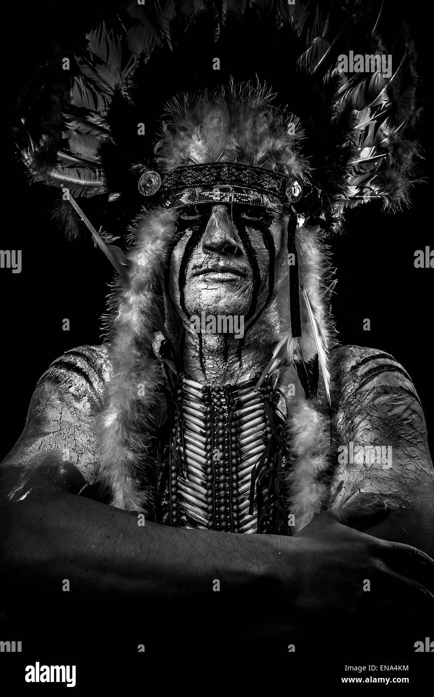 warrior Native, American Indian chief with big feather headdress Stock Photo