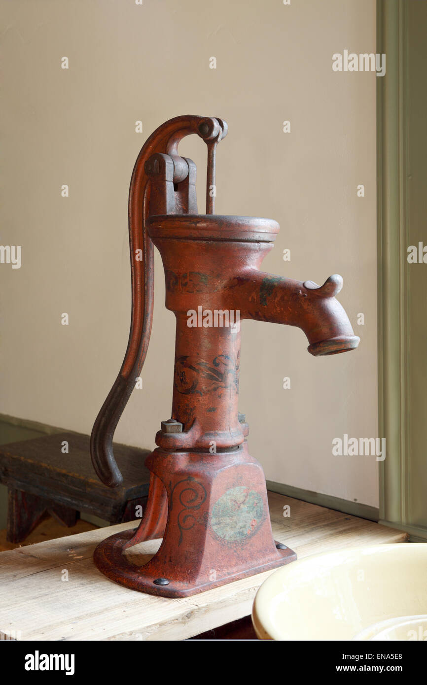 An antique indoor water pump. Stock Photo