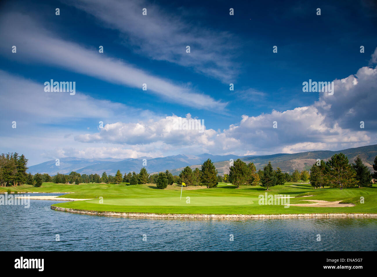 Fontanals Golf Club - amazing golf course with lake mountains and blue sky. Stock Photo
