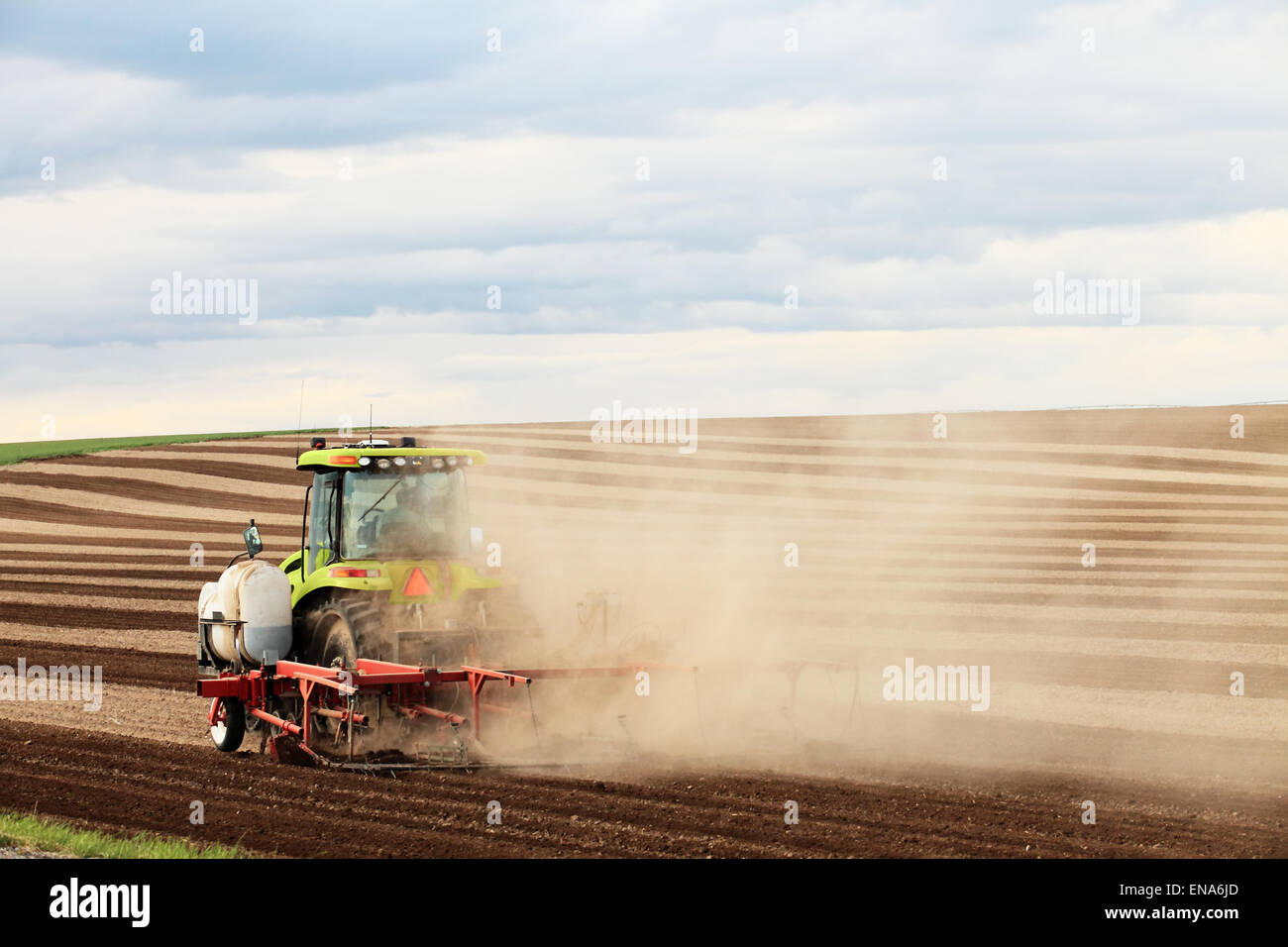 Image of a tractor plowing a field Stock Photo