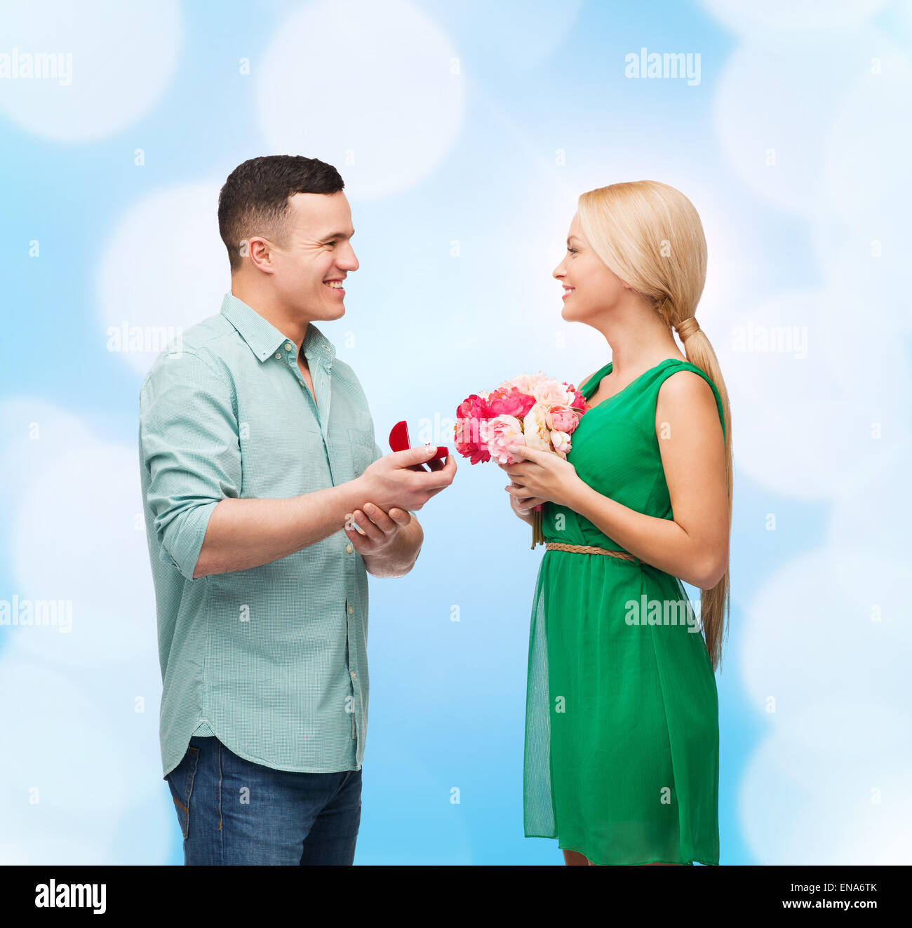smiling couple with flower bouquet and ring Stock Photo - Alamy