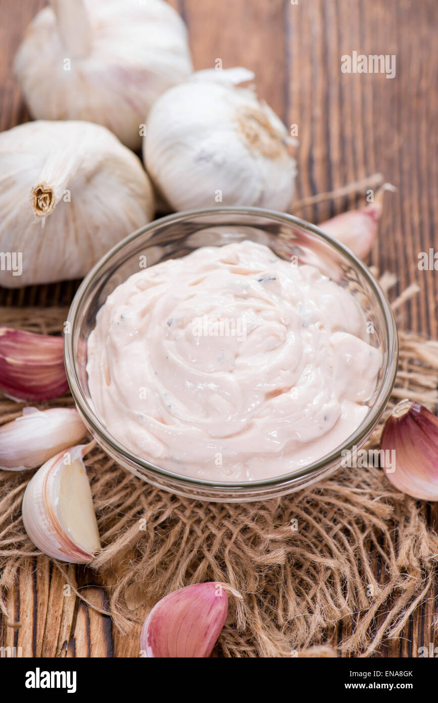 Portion of fresh homemade Aioli dip on wooden background Stock Photo
