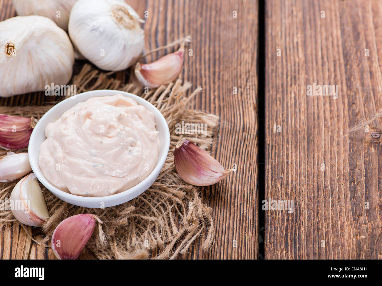 Fresh made Aioli (Garlic dip) on wooden background Stock Photo