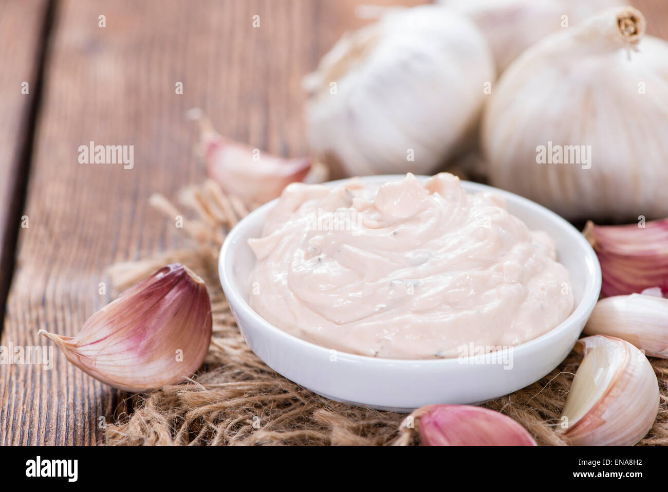 Homemade Aioli (garlic dip) on wooden background (close-up shot) Stock Photo
