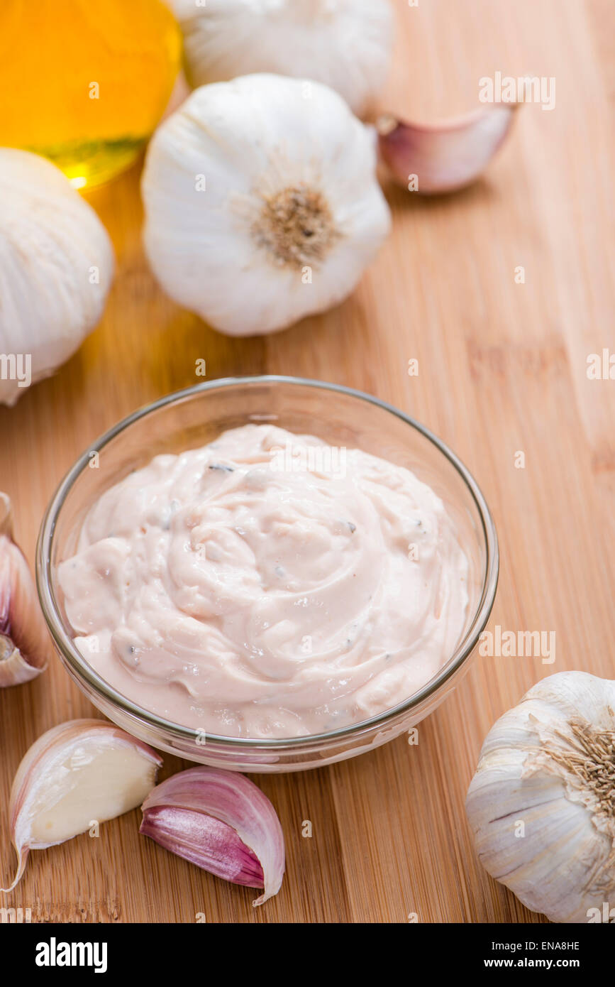 Portion of fresh homemade Aioli dip on wooden background Stock Photo