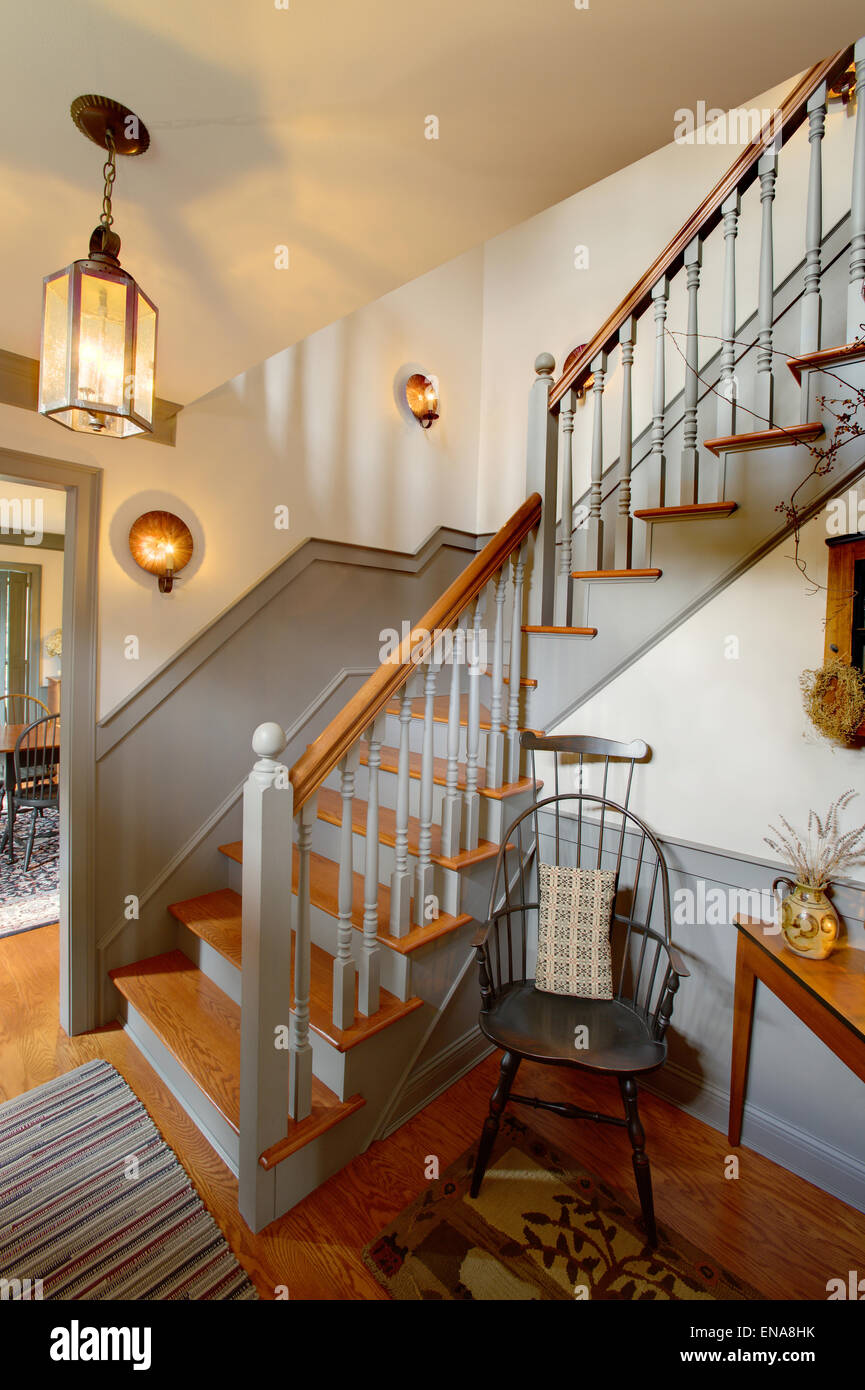 A modernized staircase in a primitive colonial style reproduction home. Stock Photo