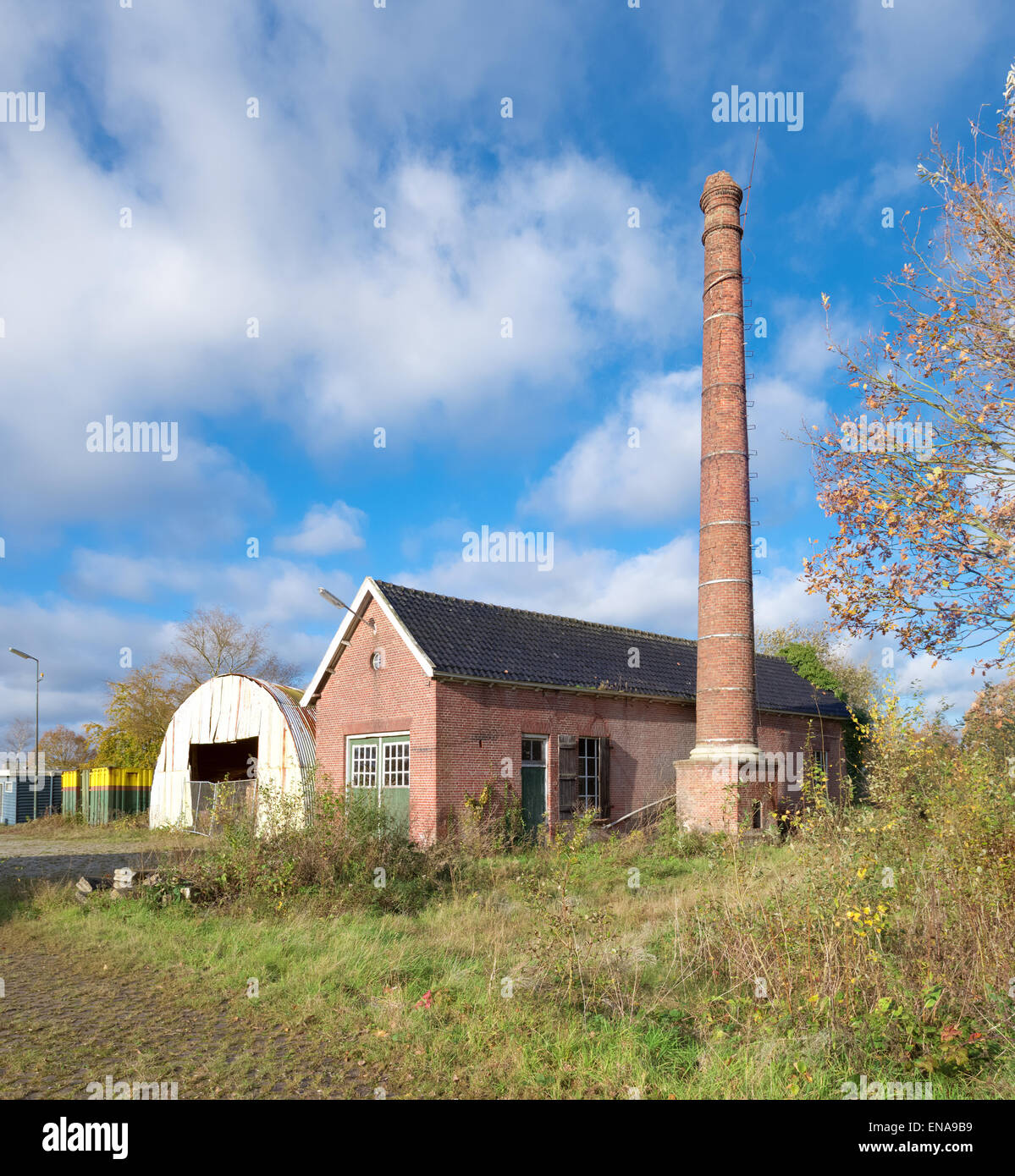 exterior of an old decayed building with brick chimney Stock Photo