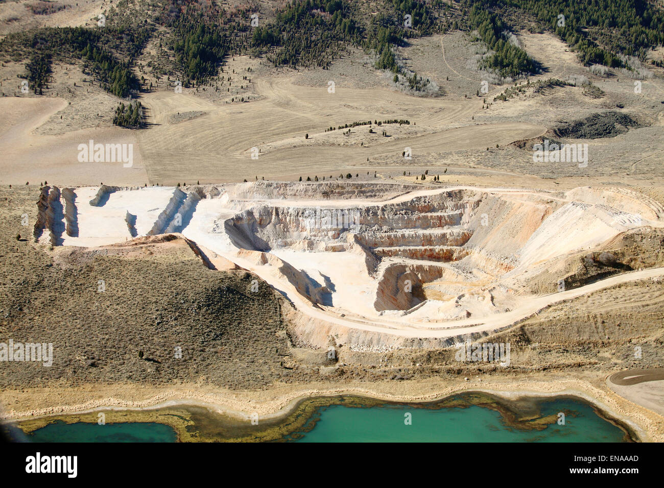 An aerial view of the tiers and levels of excavation in an open pit phosphate mine. Stock Photo
