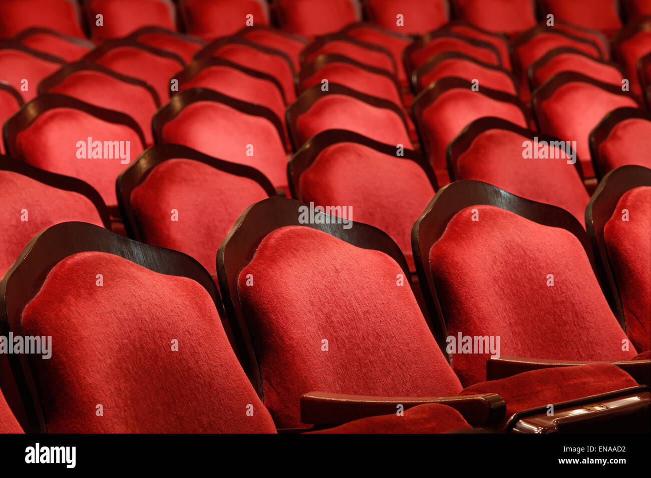 Rows of red velvet theater seats in an old Vaudeville style theater. Stock Photo