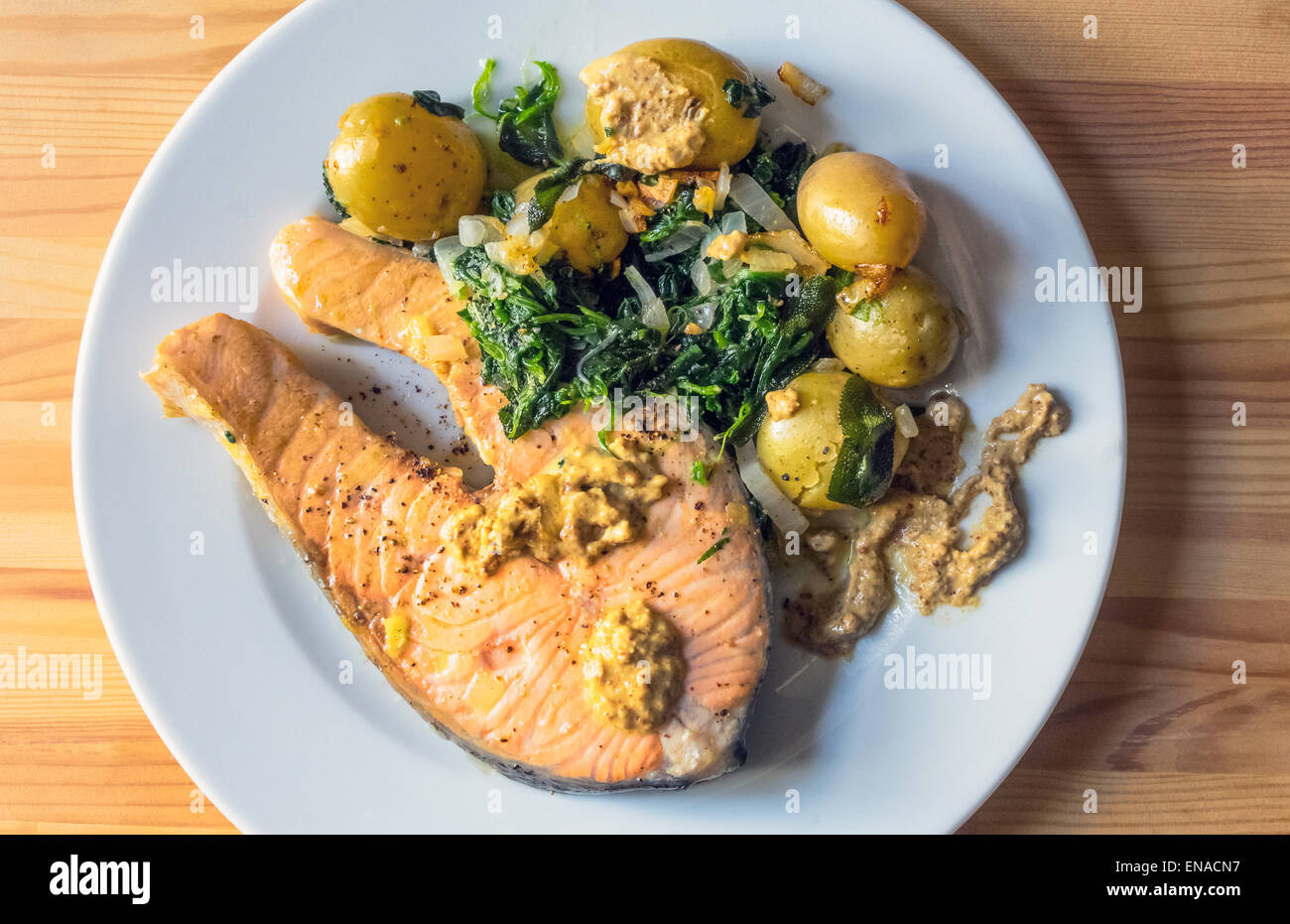Grilled salmon steak with new baby potatoes and spinach and horseradish