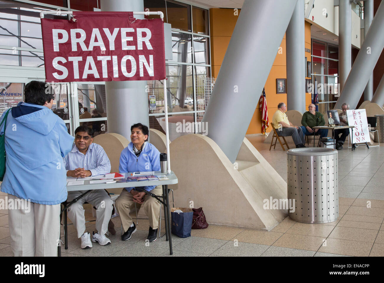 Warren, Michigan USA - Christian activists operate a 'prayer station' in the lobby of city hall. A few steps away, atheists staff a 'reason station.' Originally, the city allowed only the prayer station. It took a federal court's order to allow the atheists to set up their table. Credit:  Jim West/Alamy Live News Stock Photo