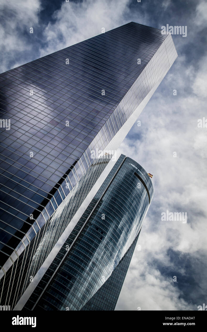 skyscraper with glass facade and clouds reflected in windows Stock ...