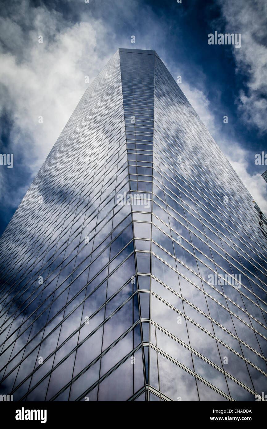 skyscraper with glass facade and clouds reflected in windows Stock ...
