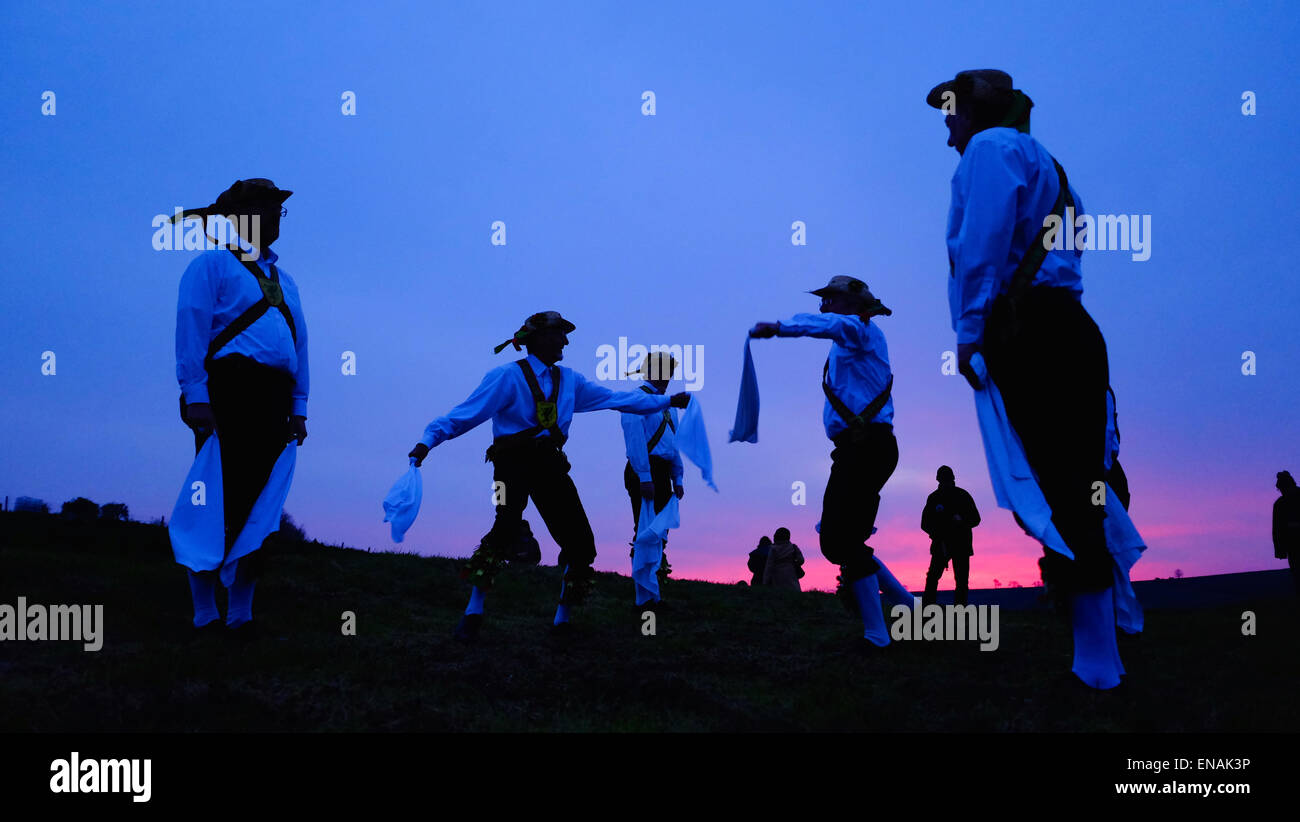 Cerne Abbas, Dorset, UK. 1 May 2015. The Wessex Morris Men celebrate May Day during sunrise at the old maypole site above the head of the Cerne Abbas Giant before parading through the Village. May Day, a traditional day of celebrations for centuries, is most associated with towns and villages celebrating springtime fertility. Credit:  Tom Corban/Alamy Live News Stock Photo