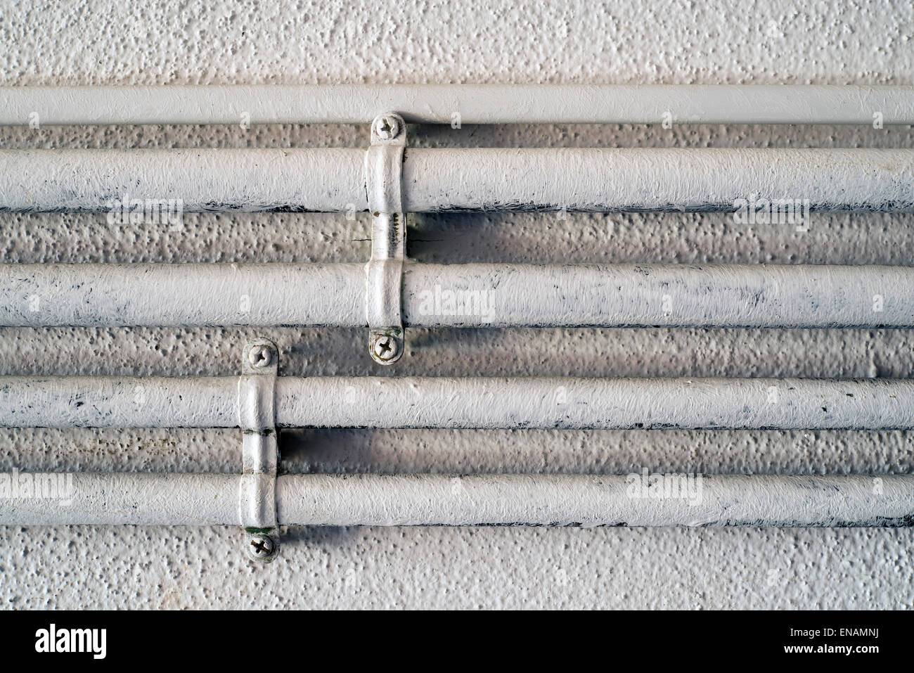 White wall and electrical conduit pipes Stock Photo - Alamy
