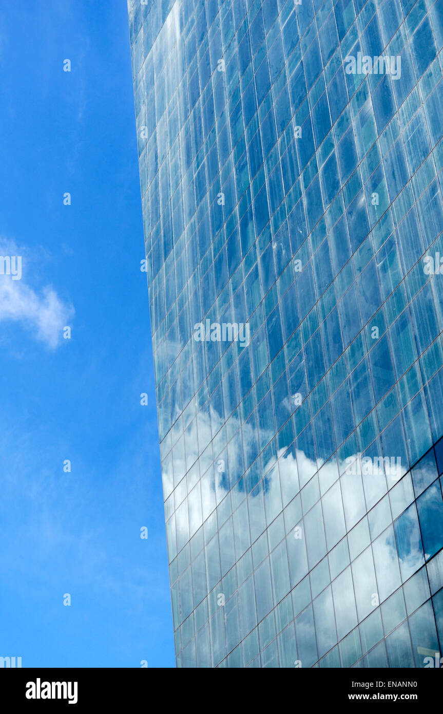 Clouds and blue sky reflected in the glass facade of an office tower in downtown Vancouver, BC, Canada Stock Photo