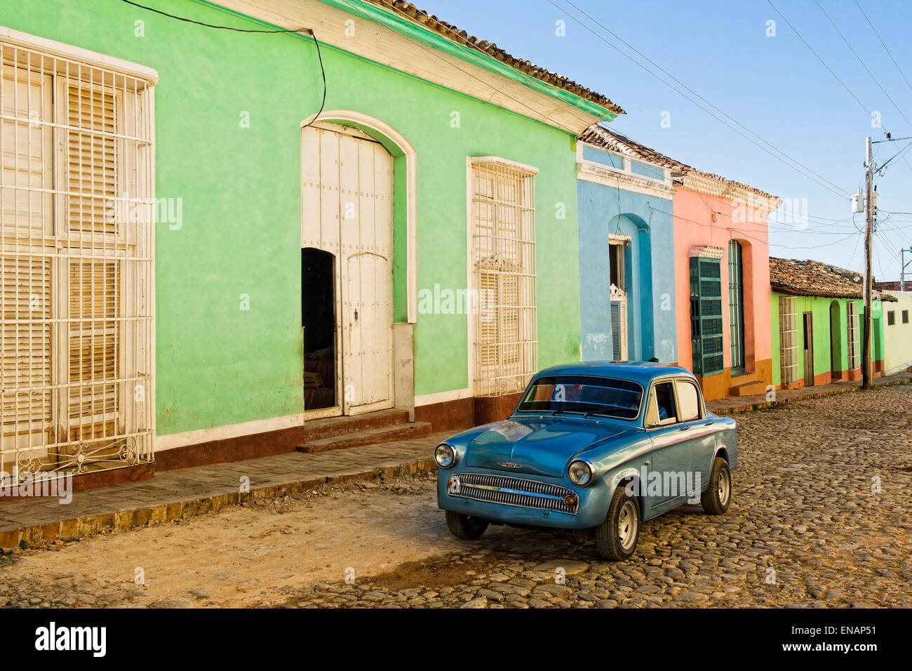 Oldtimer in front of colorful colonial Houses, Trinidad, Sancti Spiritus Province, Cuba, Central America, Unesco World Heritage Stock Photo