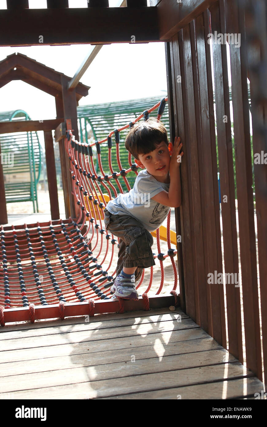 Young boy plays on a jungle Gym Stock Photo