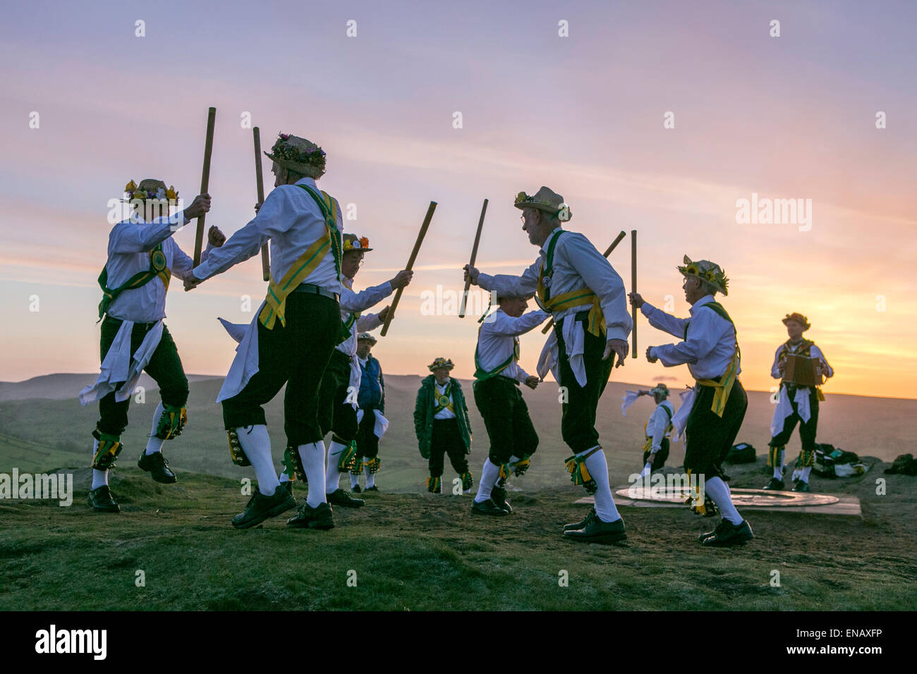 Morris dancers from the ChapelenleFrith Morris Men dance at sunrise