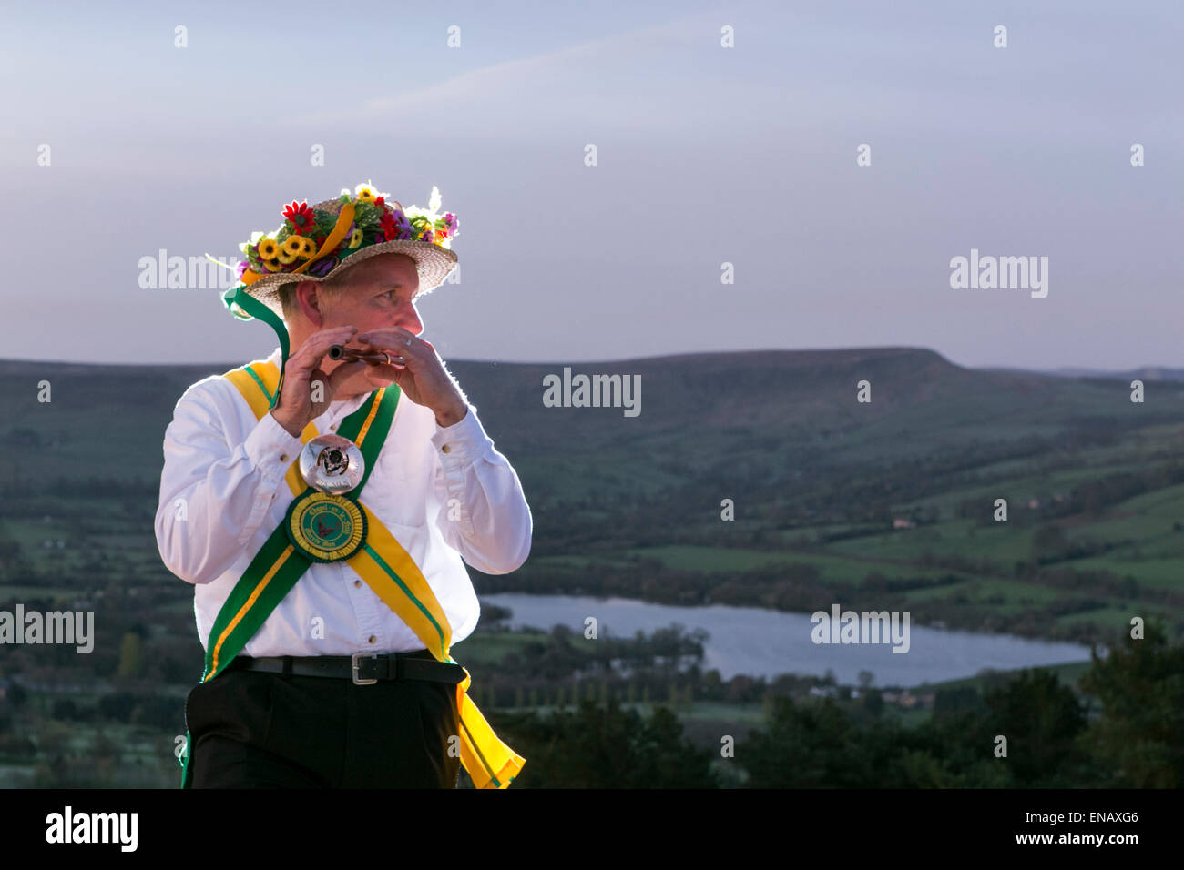 Morris dancers from the Chapel-en-le-Frith Morris Men dance at sunrise to welcome May Day on Eccles Pike Stock Photo