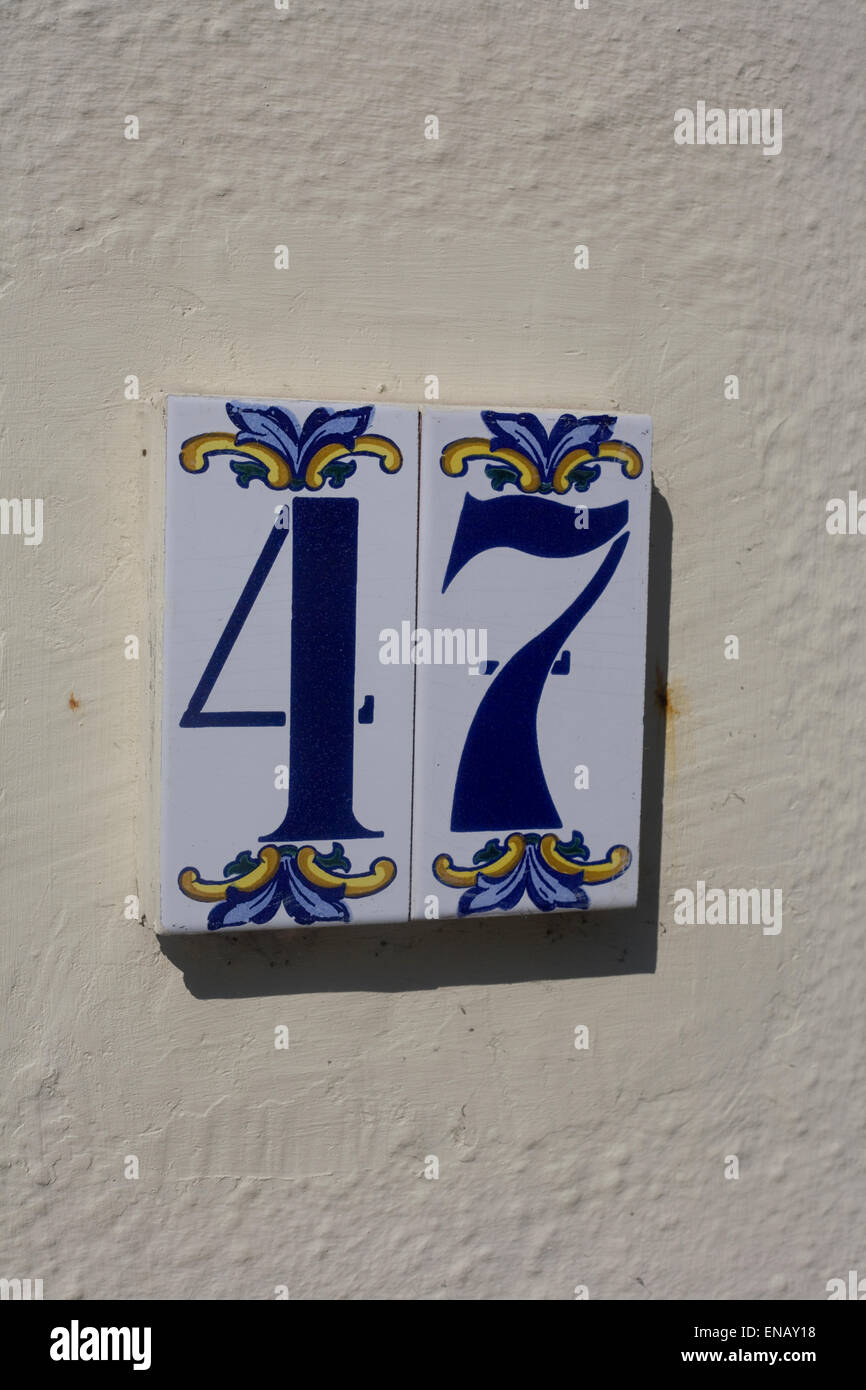 blue number 47 on white tile on wall in Emsworth Stock Photo