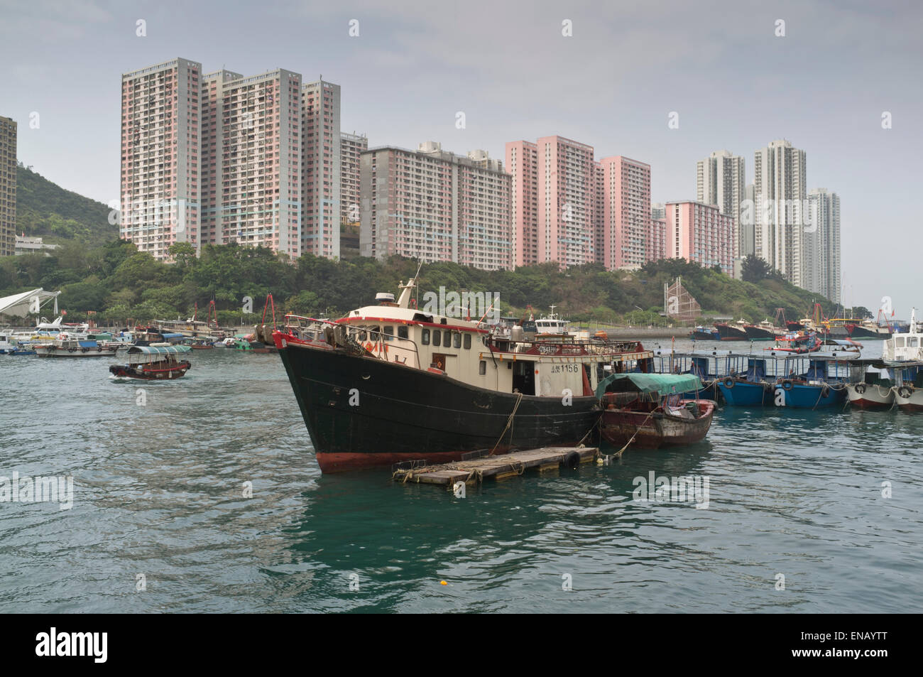 dh Aberdeen harbour ABERDEEN HONG KONG Fishing boat anchored in harbour Ap lei Chau highrise flats Stock Photo