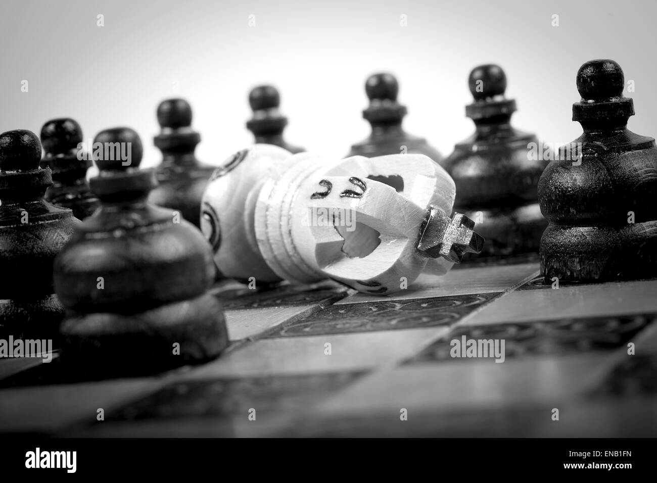 Checkmated King On Old Wooden Chessboard With Black Pawn Around checkmated-king-on-old-wooden-chessboard-with-black-pawn-around