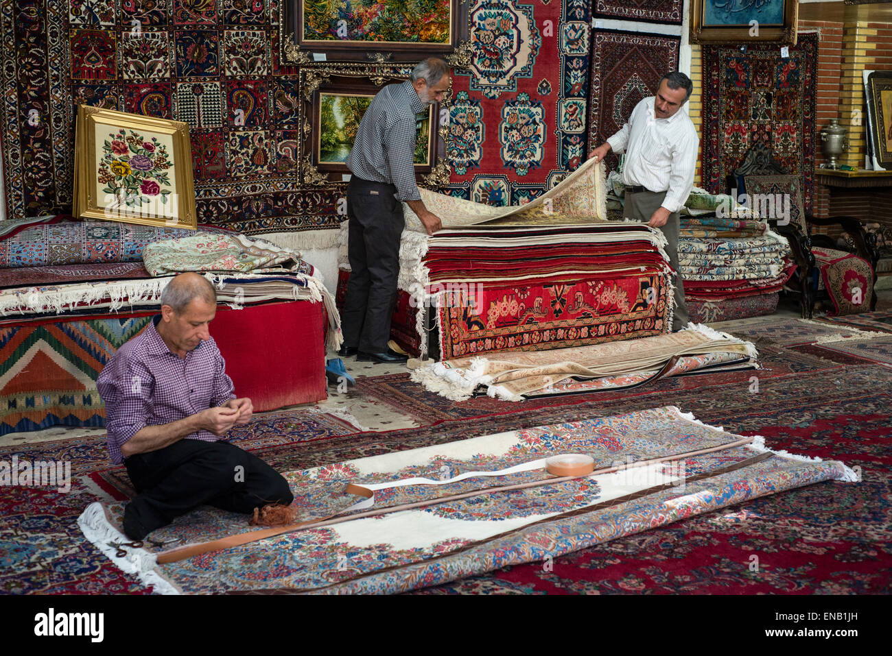 Worker sew underneath to Persian carpet in the carpet shop, Tehran