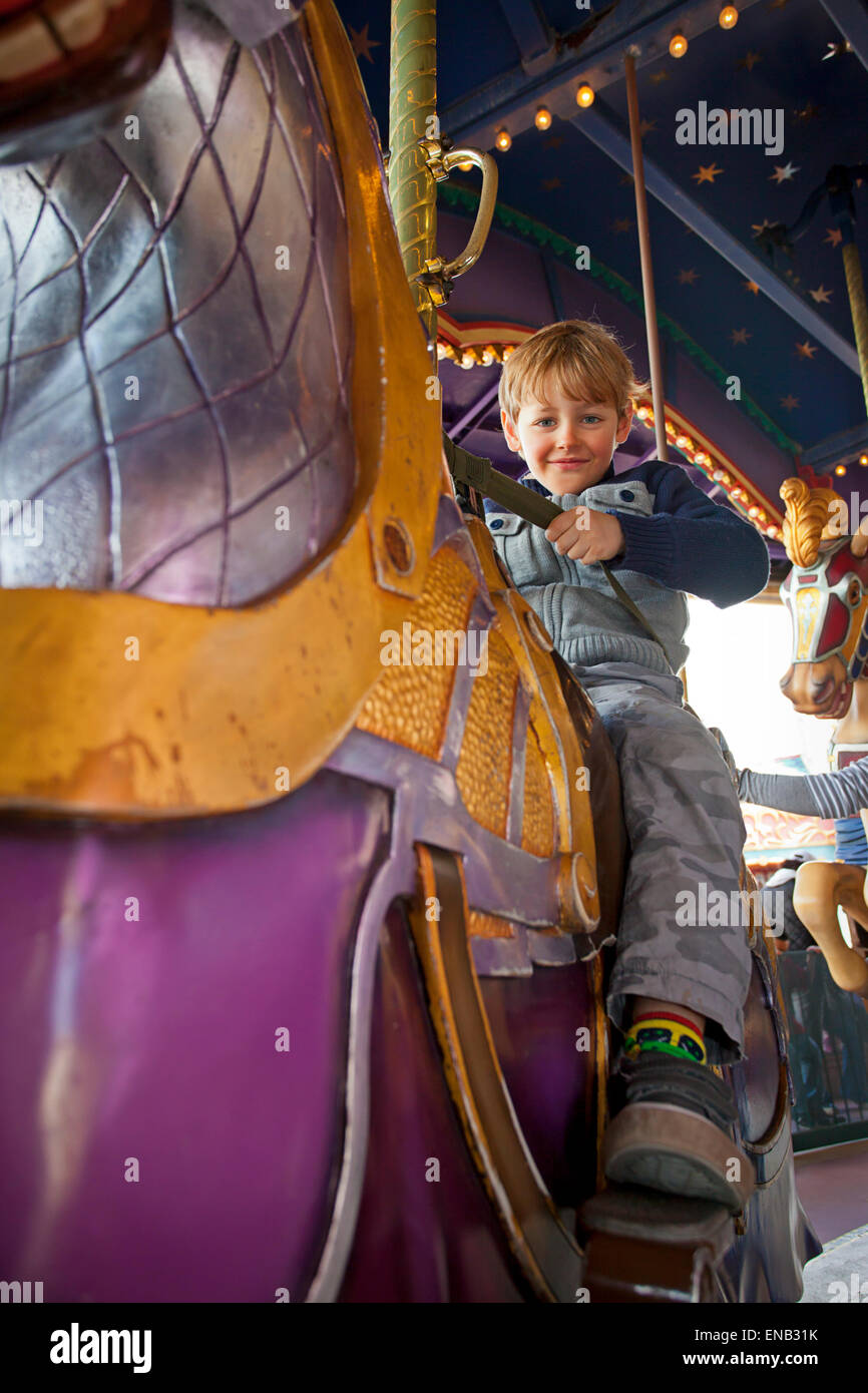 boy riding a carousel horse, Fantasyland, Disneyland Stock Photo