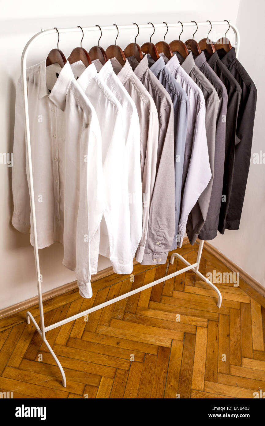 Several shirts on a hanger from white to black color range Stock Photo ...