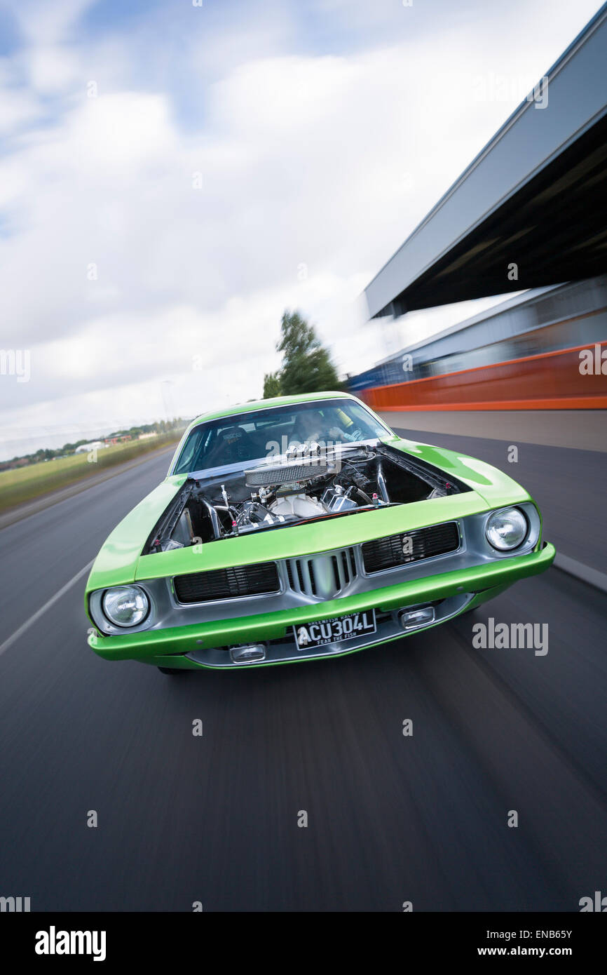 Plymouth Barracuda in an urban location in motion, moving, panned, rig shot. Stock Photo
