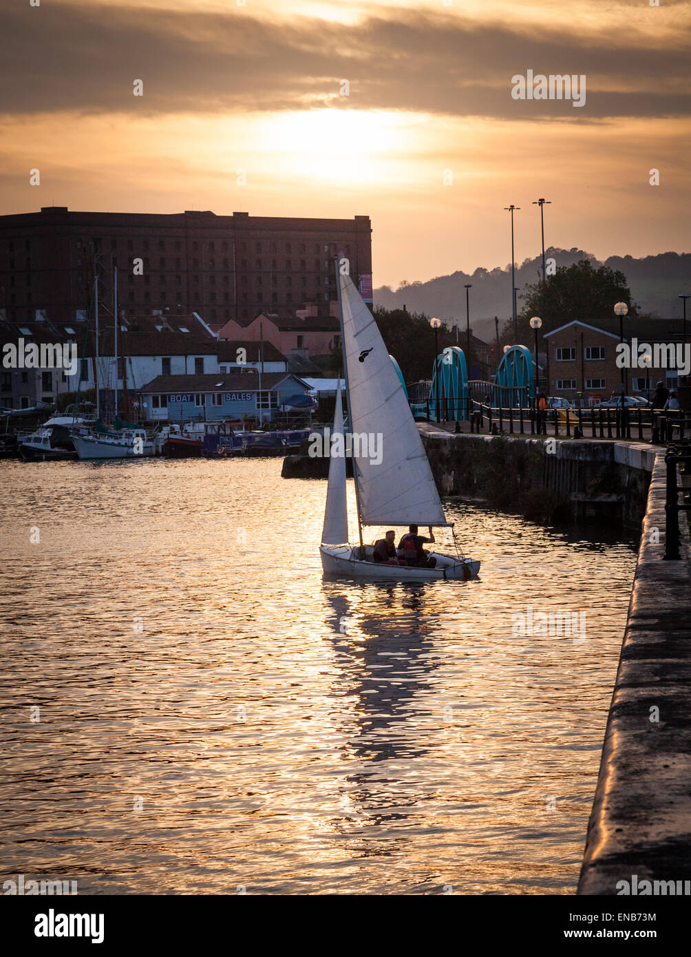 People sailing on the Floating Harbour in Bristol at sunset Stock Photo