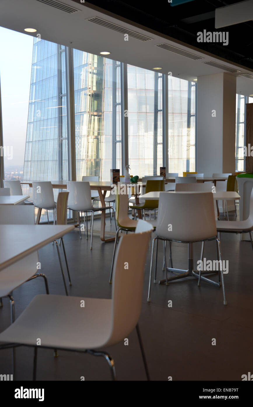 Looking out at London from a modern skyscraper, tables and chairs in a
