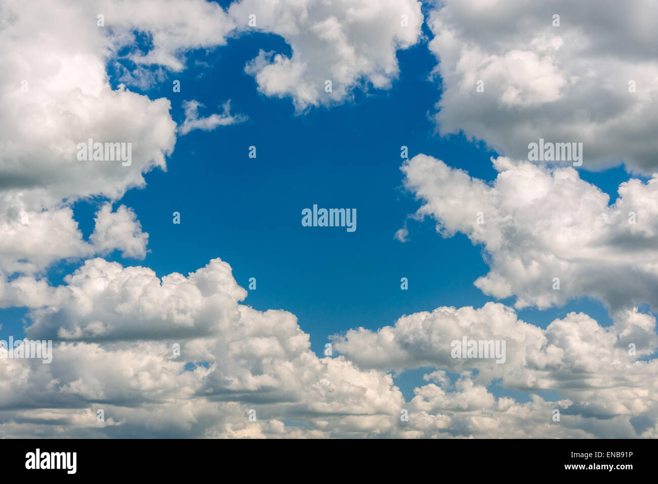 The clouds part to reveal a blue sky during fine spring weather. Stock Photo