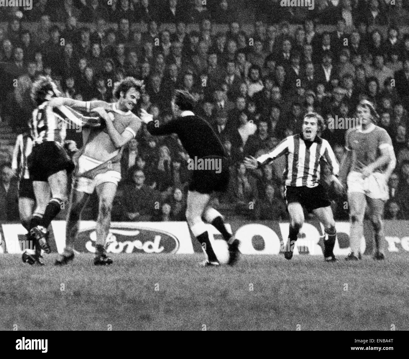 Manchester City v Stoke City league match at Maine Road, Saturday 9th November 1974. Rodney Marsh clashes with Terry Conroy under watchful eye of referee, also pictured, John Mahoney & Alan Oakes (right). It resulted in Conroy being booked. Final score: M Stock Photo