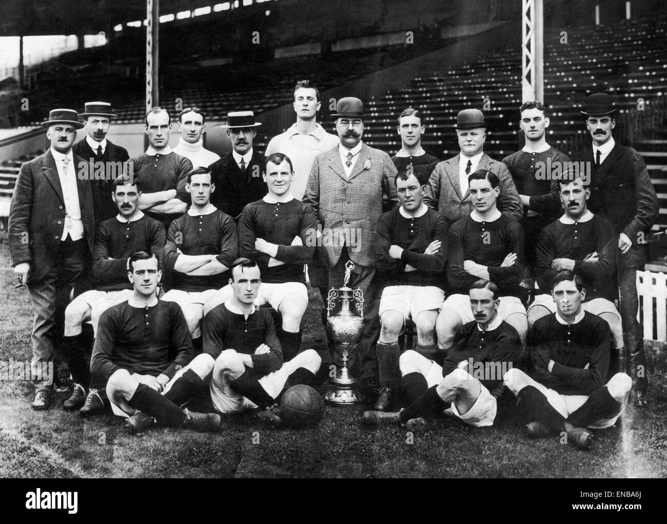 Manchester United team pose for a group photograph with the League Championship trophy. Standing left to right: J. E. Magnall (Secretary), F. Bacon, Picken, Edmonds, Mr Murray (Director), Moger, Mr H Davies, T Homer, Mr Lawton (Director), A Bell, Mr Deaki Stock Photo