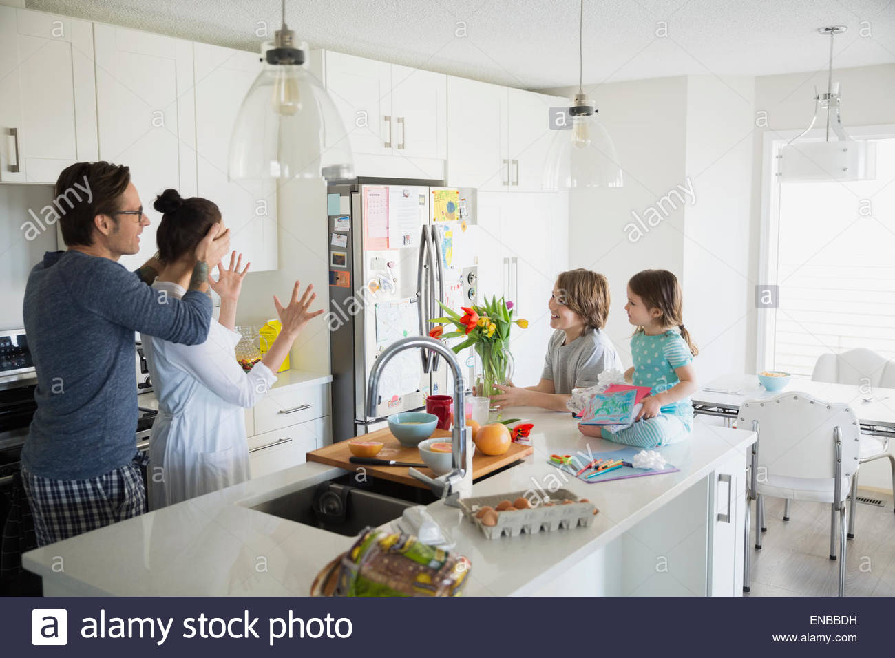 Father and children surprising mother on Mothers Day Stock Photo
