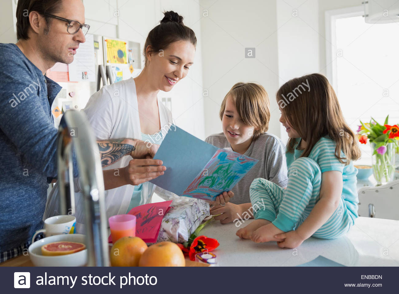 Family watching mother read homemade Mothers Day card Stock Photo