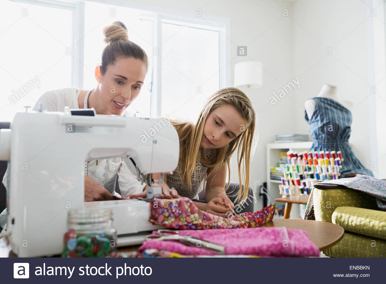 Mother teaching daughter to sew at sewing machine Stock Photo Alamy