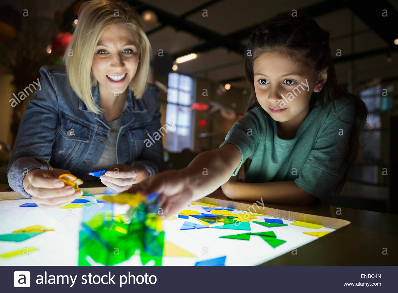 Mother daughter assembling geometric shapes at science center Stock Photo