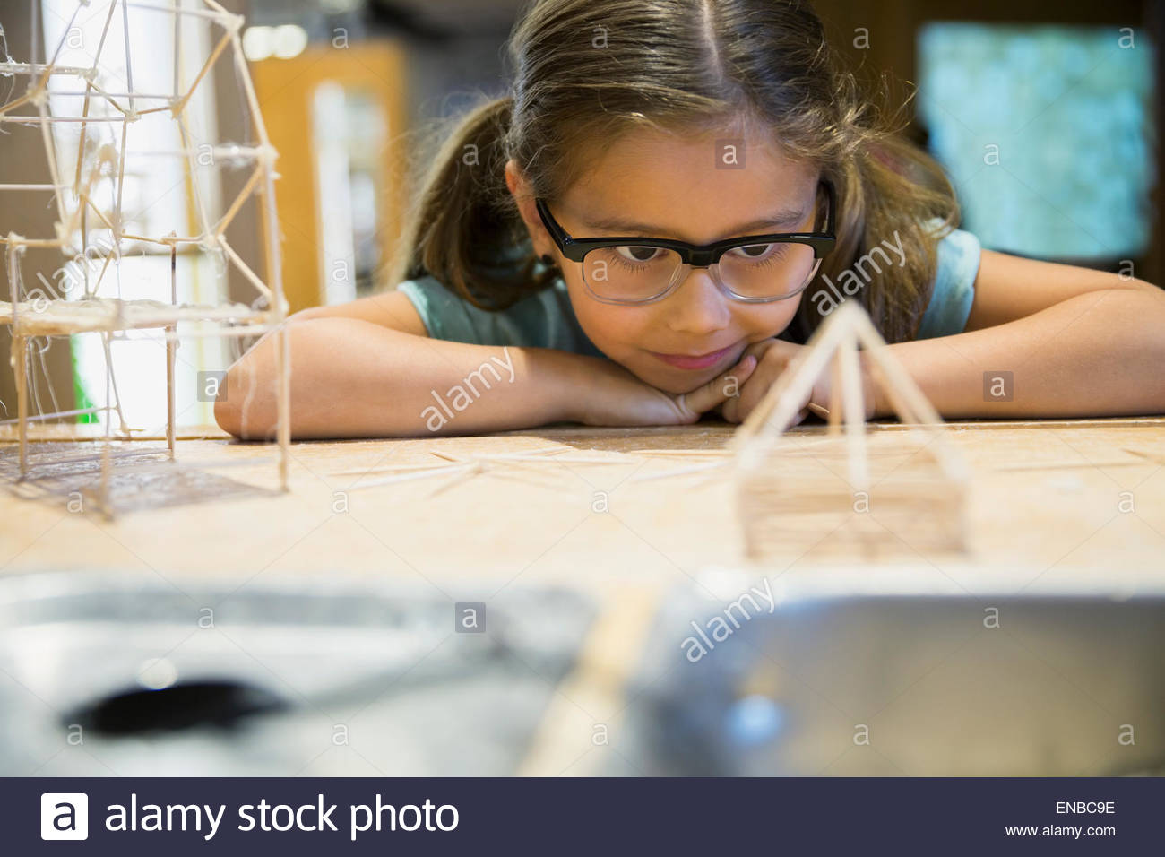 Girl examining toothpick model at science center Stock Photo - Alamy