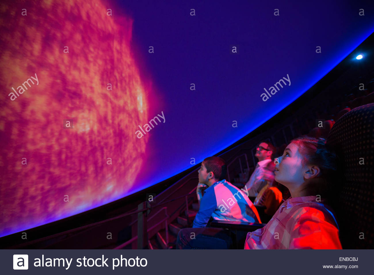 Students watching planet at planetarium show Stock Photo