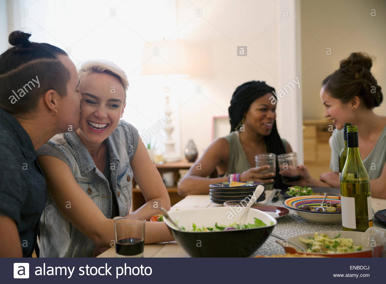 Couple kissing at dinner party Stock Photo