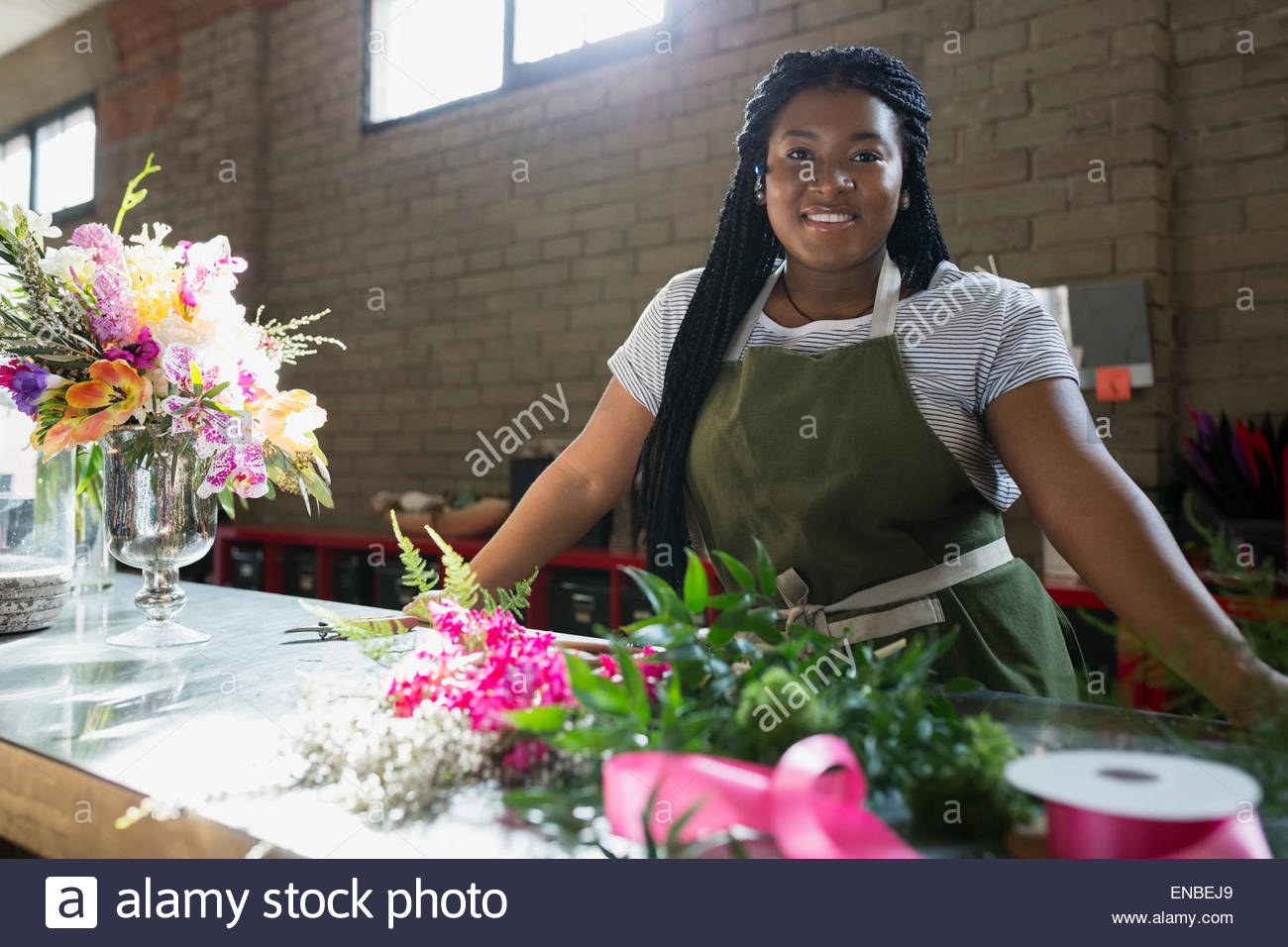 Portrait smiling florist in flower shop Stock Photo