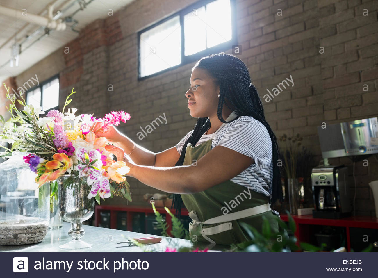 Florist arranging bouquet in flower shop Stock Photo